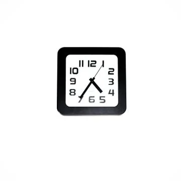 Wall clock - square black wall clock on a white wall Stock Photos