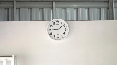 The wall clock on a white wall Stock Footage 256138628