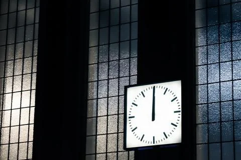 Wall clock on windowed building interior Stock Photos