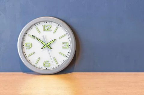 Wall clock on the wooden table. 3D rendering Wall clock on the wooden tabl... Stock Photos