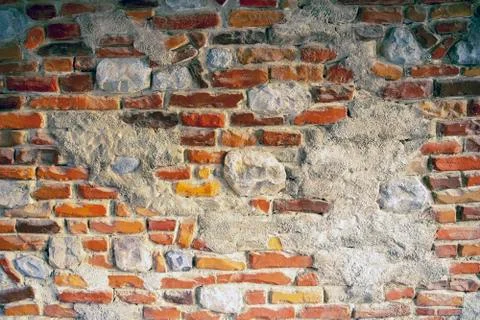 Wall of colorful bricks mixed with  light natural stones Stock Photos