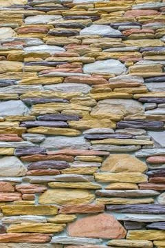Wall with colorful stone in stack as texture Foto stock