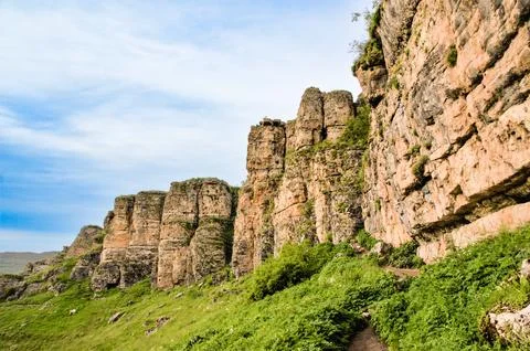 A wall of columnar rocks. Stock Photos