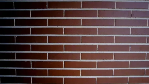Wall composed by 10 rows of bricks with light coming from the right and shadows Stock Footage 120556131