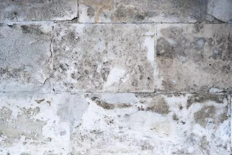 Wall of concrete blocks with a damaged surface. Stock Photos