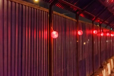 Wall on a construction site with red light bulbs Stock Photos