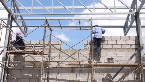 Wall construction worker build concrete wall by cement block. Video stock 75712685