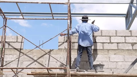 Wall construction worker build concrete wall by cement block. Video stock 75713307