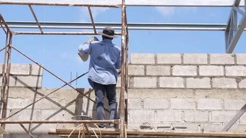 Wall construction worker build concrete wall by cement block. Video stock 75715091