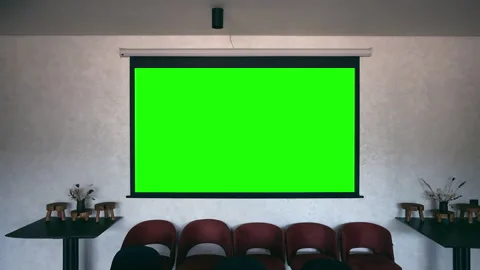 The wall contains a green projector screen. Stock Footage 311241312