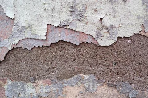 The wall is covered with many layers of paint and rust Stock Photos