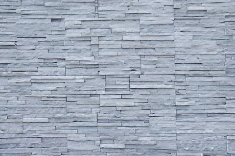 Wall covered with thin slabs of gray limestone Stock Photos