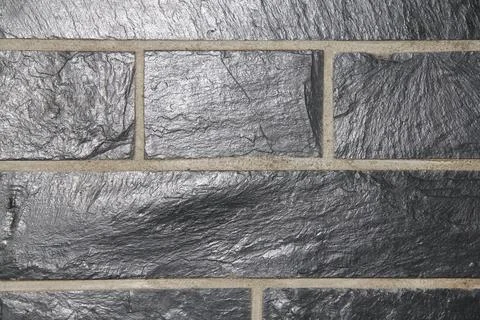 A wall covering with rectangular gray slates Stock Photos