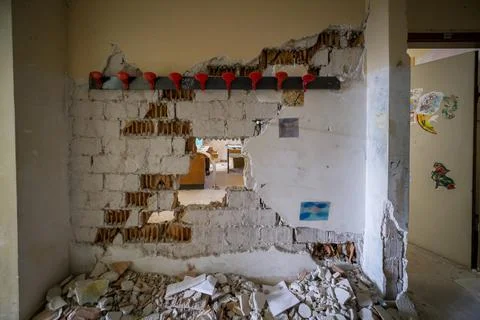 Wall with cracks fallen in abandoned elementary school Stock Photos