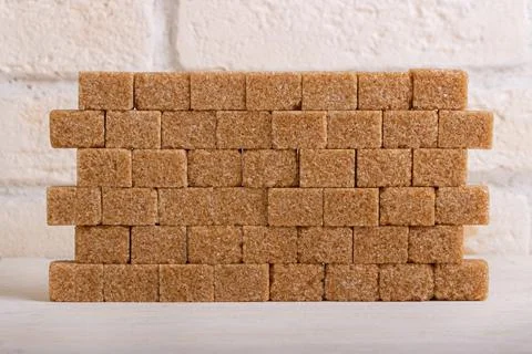 Wall of cubes of cane sugar Stock Photos