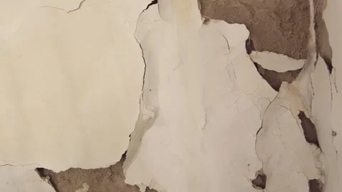 A wall damaged by moisture, peeling plaster, close-up, poor quality repairs Stock Footage 320819676