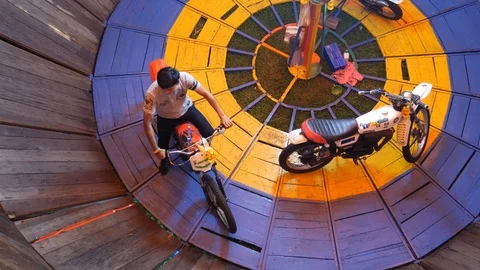 Wall of Death, Motorcycle running on the vertical wall of wooden cylinder Stock Footage 107729797