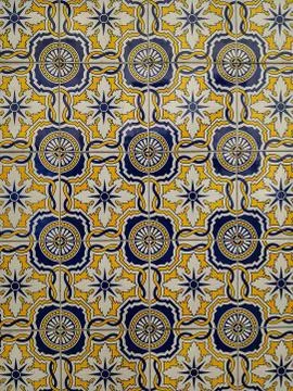 Wall decorated with tiles of various models Stock Photos