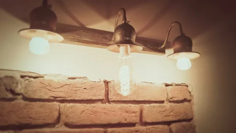 Wall with decorative old bricks in it, illuminated by lamps Stock Footage 155079326