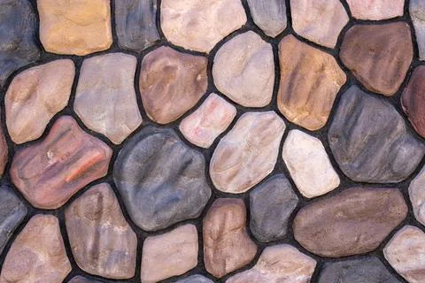 A wall with different colored stones in a structure 写真素材