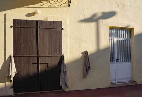 Wall with a door and a window in the light of the setting sun with beautiful Stock Photos