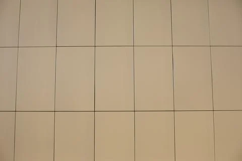 Wall of facing panels. The white wall of the shopping center. Stock Photos