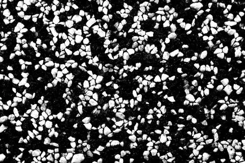 A wall, a floor consisting of many small stones of black and white colors. A Stock-Fotos