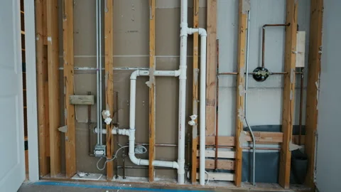 Wall framing with plumbing pipes during house renovation. Construction phase Stock Footage 332185958