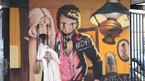 Wall graffiti bleeding couple Stock Footage 56069449