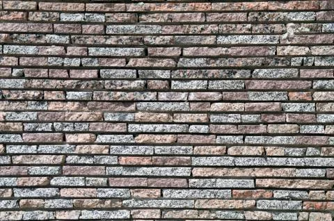 Wall from a granite brick Stock Photos