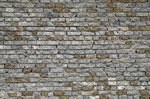 Wall from a granite brick Stock Photos