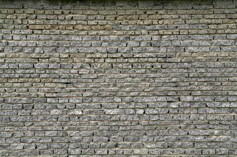 Wall from a granite brick Stock Photos