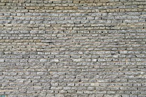 Wall from a granite brick Stock Photos