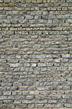 Wall from a granite brick Stock Photos