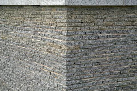 Wall from a granite brick Stock Photos