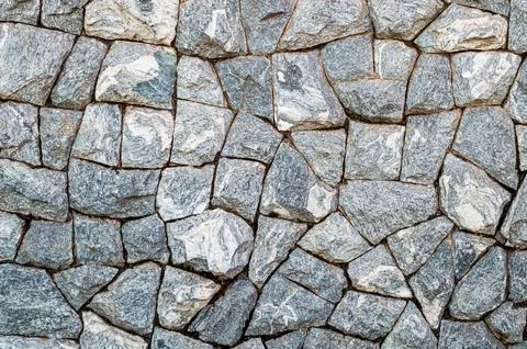 Wall of gray cracked stones. Pattern. Advertising space. Design element. Backgro Stock Photos