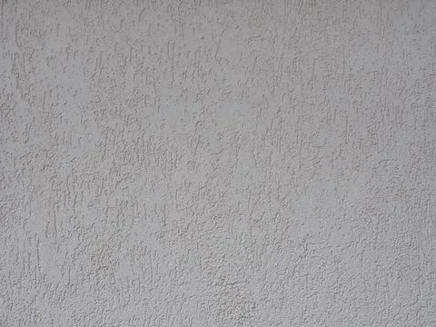 Wall with gray embossed decorative cladding. The texture is not seamless. Full Stock Photos