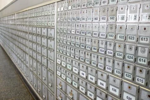 The wall of grey post office boxes in perspective Foto stock