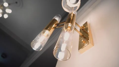 On the wall hangs a beautiful lamp illuminating the room Stock Footage 248523307