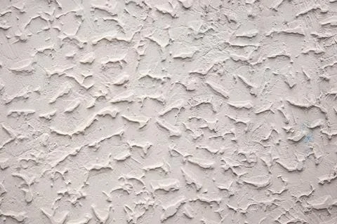 The wall has a textured surface with a pattern of lines Stock Photos