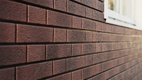 The wall of the house with plastic clinker panels with imitation of stone Stock Footage 166748138