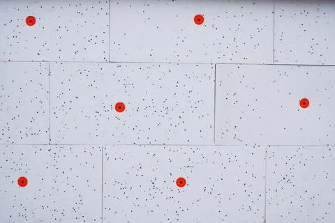 Wall insulation made of pinoplast. Texture with black splashes and red fasten Stock Photos