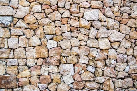 Wall of irregular stones Stock Photos