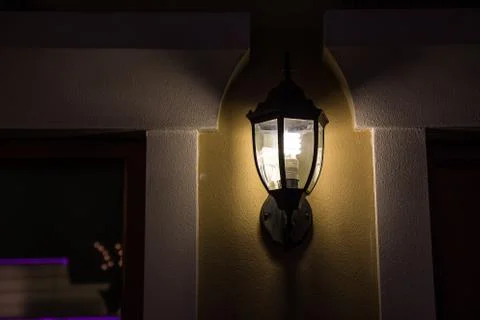 The wall lamp is on fire at night. 写真素材
