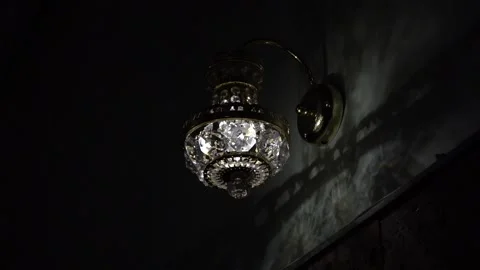 The wall lamp glows in a dark room 스톡 동영상 188541908