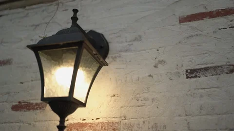 Wall lamp with a warm light on the brick walls. Stock Footage 125087620