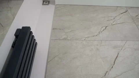 A wall of large-format ceramic tiles. Black radiators in the kitchen. Stock Footage 340335753