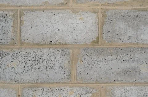 Wall of large gray brick blocks with cement joints. Stock Photos