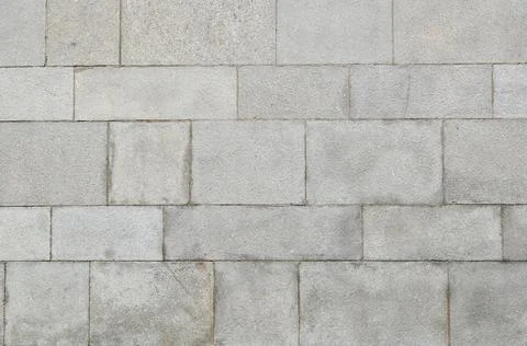 A wall of large gray stone blocks. Stock Photos