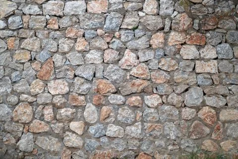 Wall of a large stone, a texture of a stone wall Stock Photos